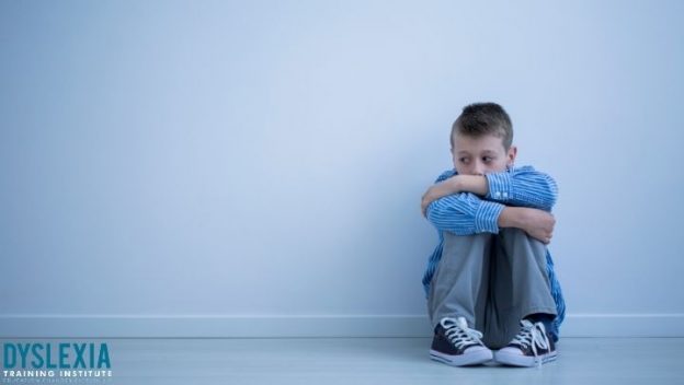 Sad child sitting on the floor - what to doif you suspect your child as dyslexia